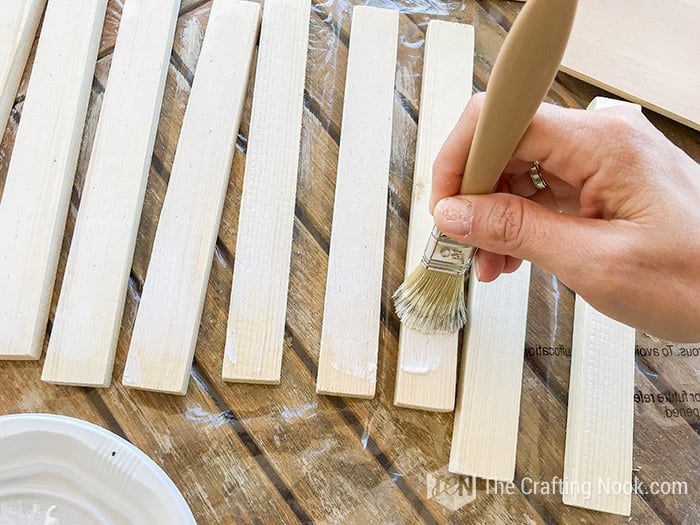 Applying white paint on the sides of the frames
