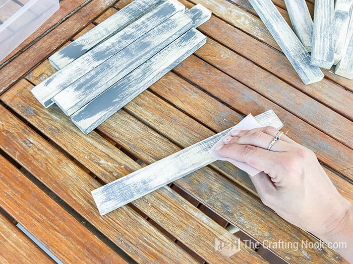 Sanding down the painted wood pieces
