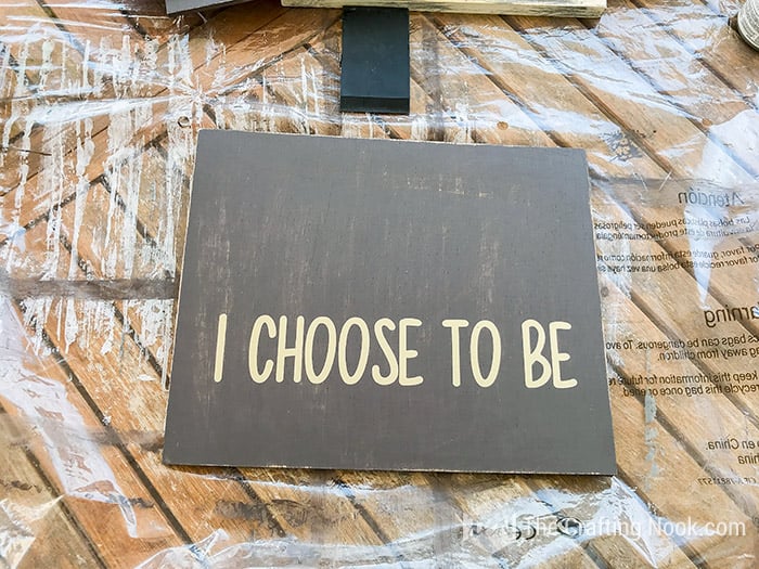 Showing the phrase "i choose to be" on wood