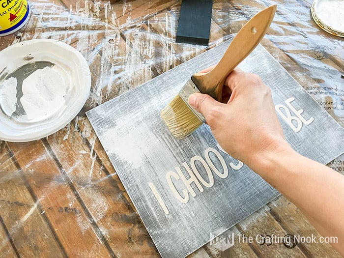 Dry brushing with white paint one of the Farmhouse Wood Signs