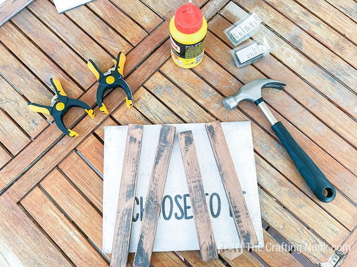 Showing the finished pieces of wood plus the hamme,r the glue, the nails
