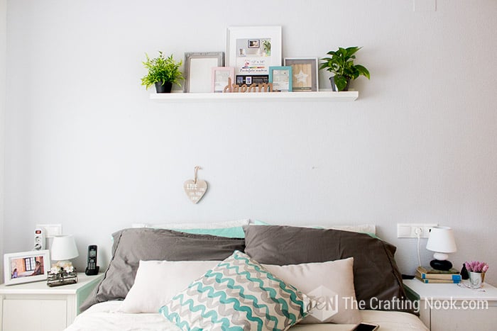 showing the wall painted in gray tome with decoration of the headboard of the room