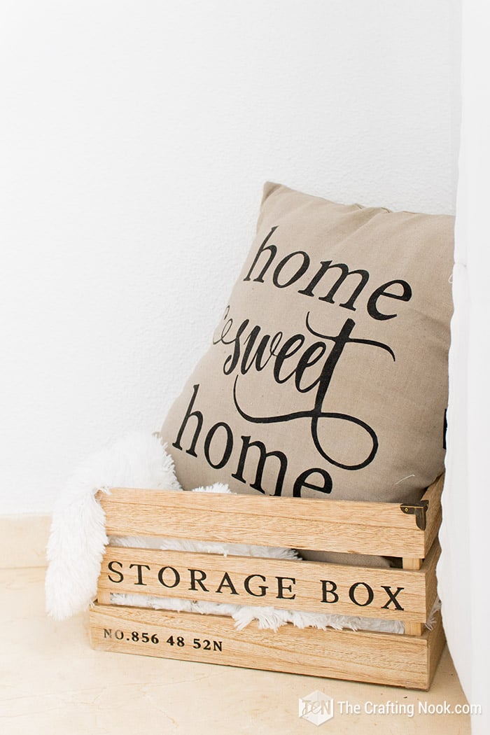 close up view of cushion inside rustic wooden box on the floor