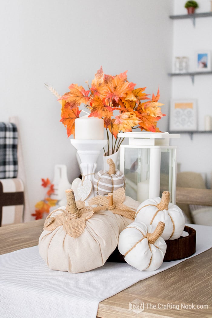 Rustic fabric pumpkins on a table.