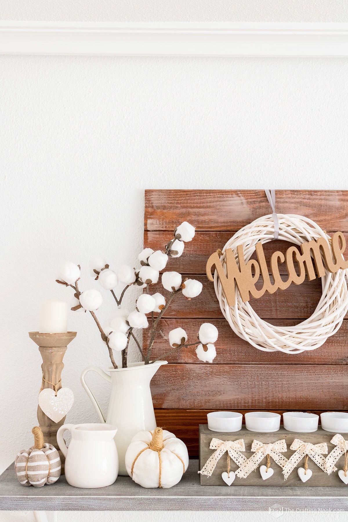 Faux DIY Cotton Stems (In a few Simple Steps) placed in a pitcher decorating a mantel