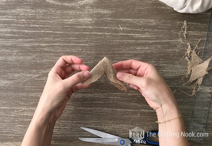 Make a cut in the center of the burlap.