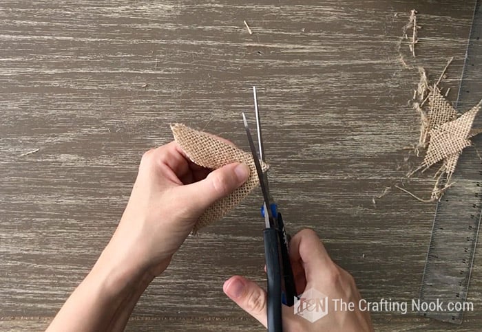 Cutting an opening at the end to fit over pumpkin stem.