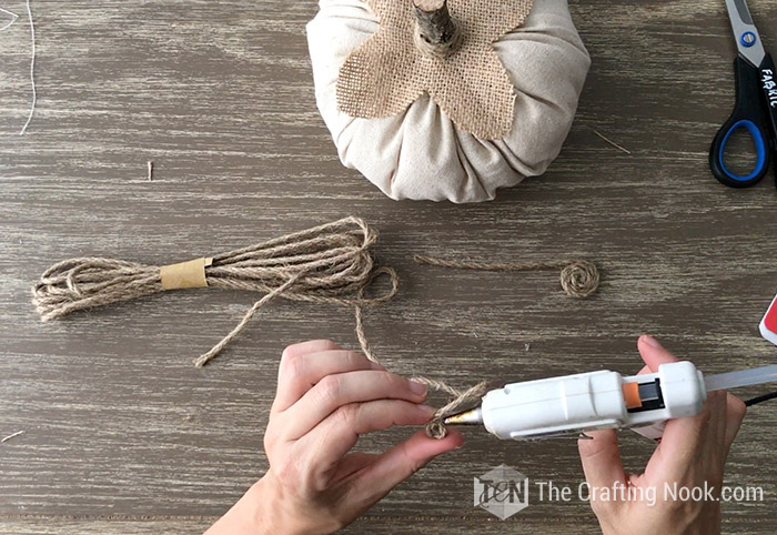 yarn wrapped in a circle with a bit of hot glue