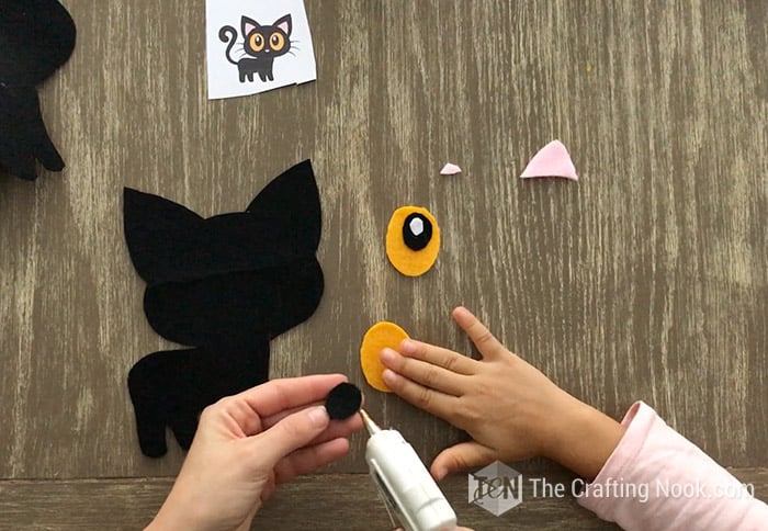 applying hot glue on felt eye pieces