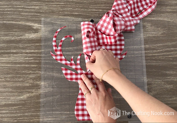 peeling away all the surrounding fabric from the mat