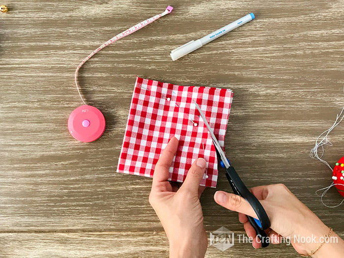 cutting the fabric at the marks with a pair of scissors