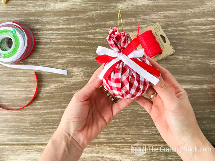 showing the ball already made with the red and white bow