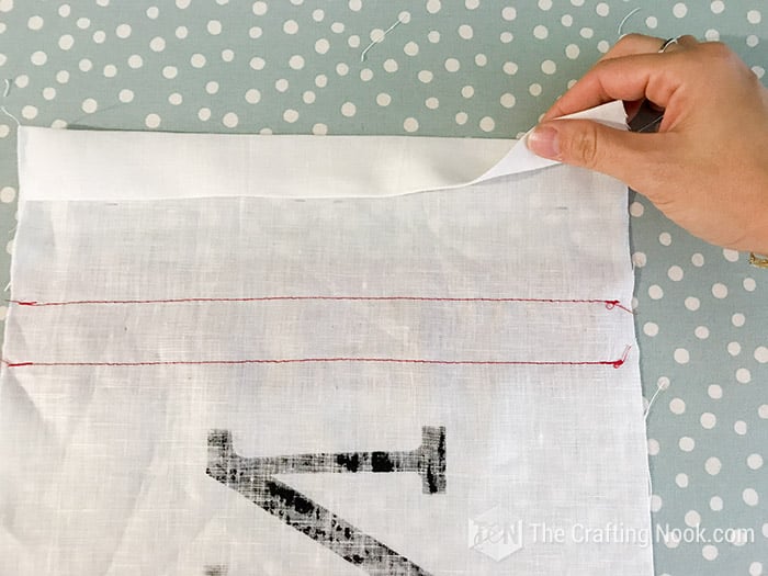 showing the machine stitching of the fabric strips on the back of the painted fabric
