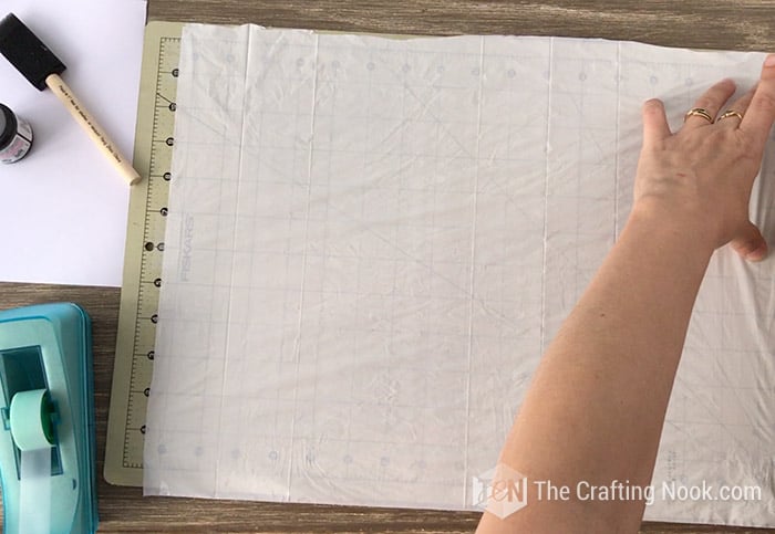 placing plastic on the cutting mat
