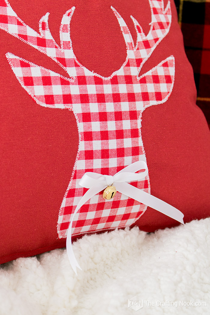 Closeup of one of the Reindeer Applique Plaid Christmas Pillows