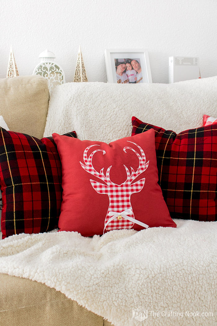 Front view of Reindeer Applique Plaid Christmas Pillows on the sofa