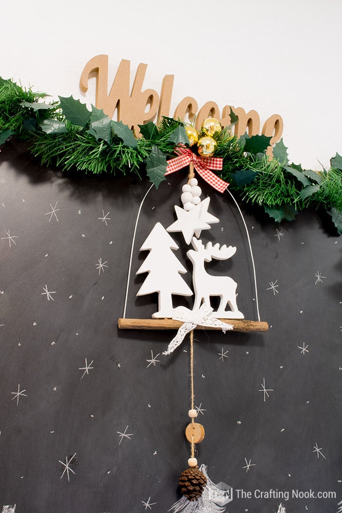 close up of Welcome wood sign decorated with ornaments, greenery, garlands,