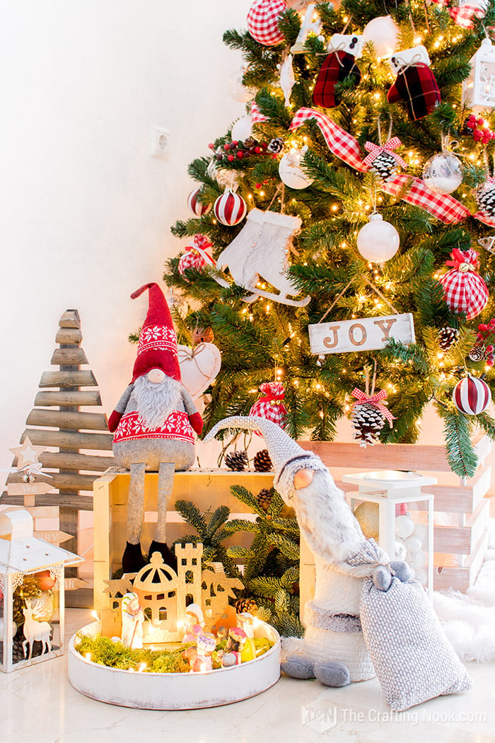 view of couple of fellas, nativity, rustic lantern around the Christmas tree