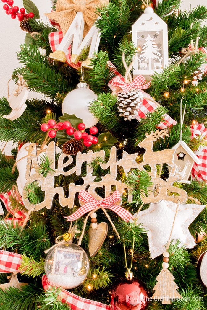 Merry Christmas Wooden sign placed on the Christmas tree