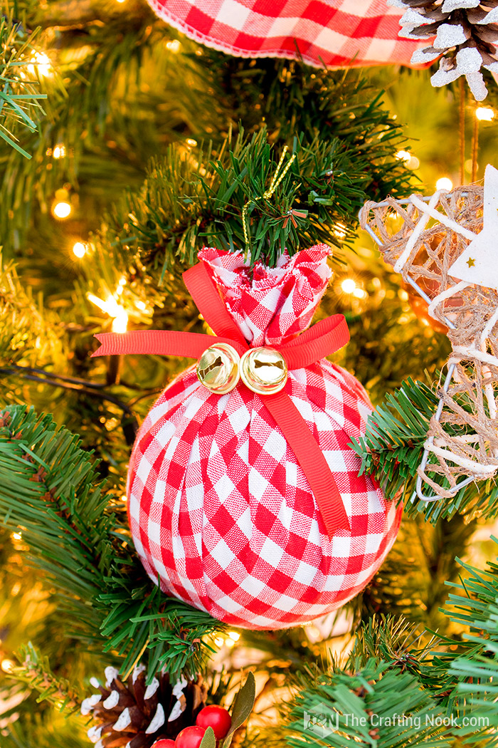 Christmas ornament wrapped in red and white buffalo check fabric