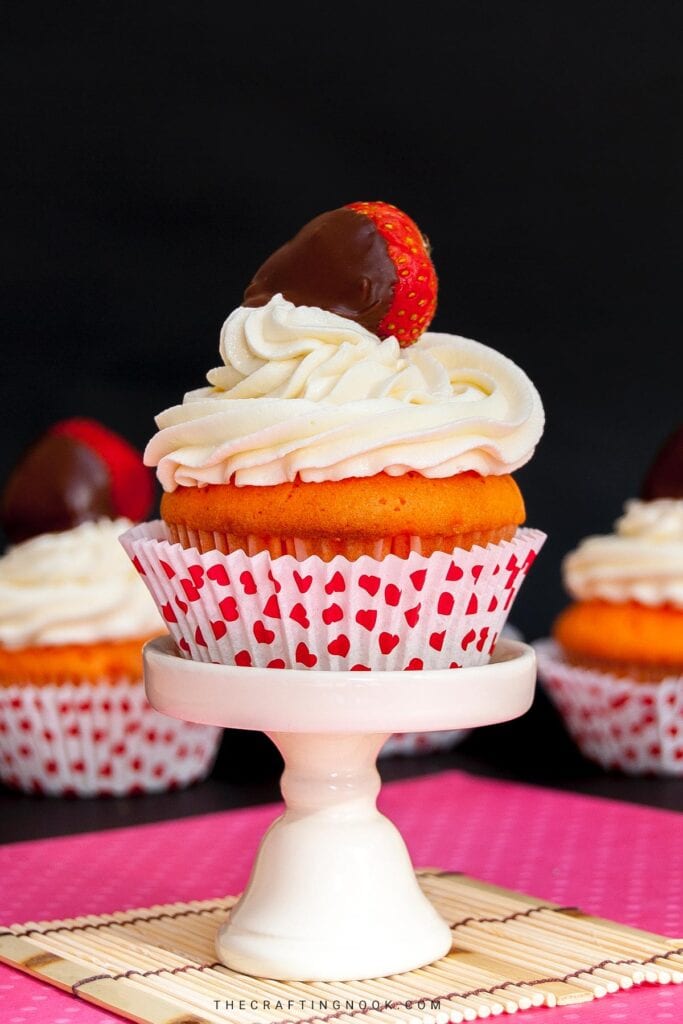 Nutella Filled Cupcakes Topped with Chocolate-Covered Strawberries and a delicious vanilla buttercream frosting recipe Cover image