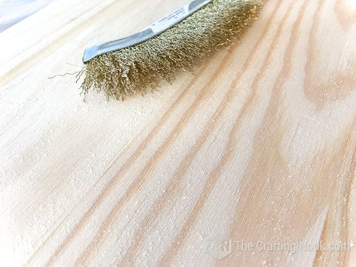 opening the wood pores with the brass-bristle scrub brush 