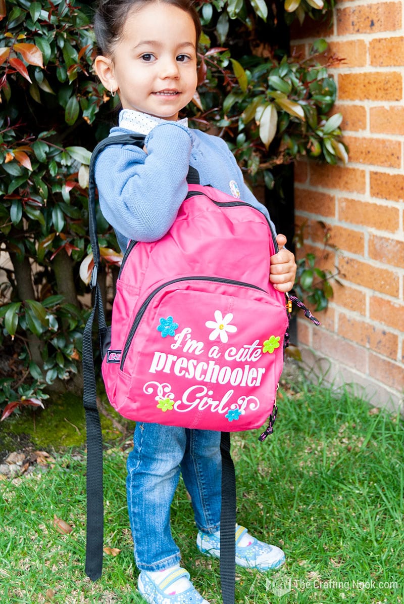 picture 1 of my daughter modeling Heat Transfer Vinyl Backpack Decoration hanging on her chest