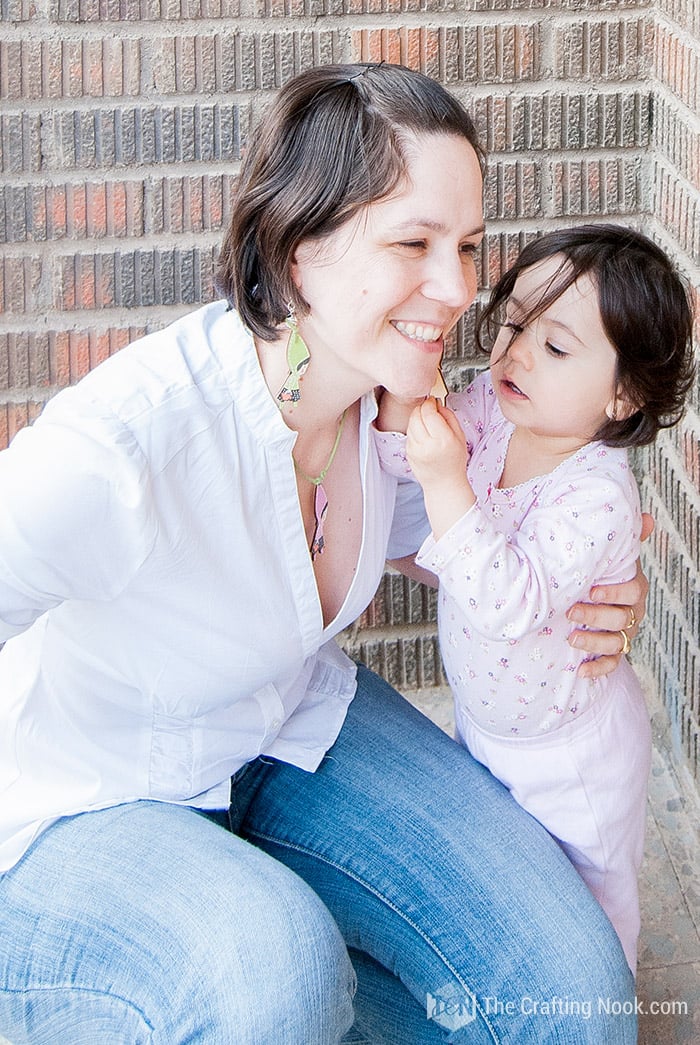 Wearing my Simple DIY Leather Necklace with Wooden Charm and Earrings and being inspected by little girl