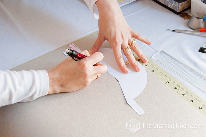 marking the shape on the cardboard with a pencil