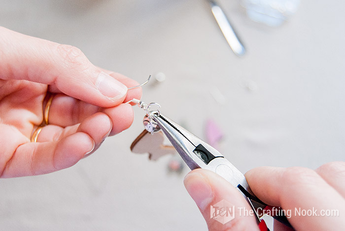 placing another ring and inserting the earring hook and the pendant with the help of pliers
