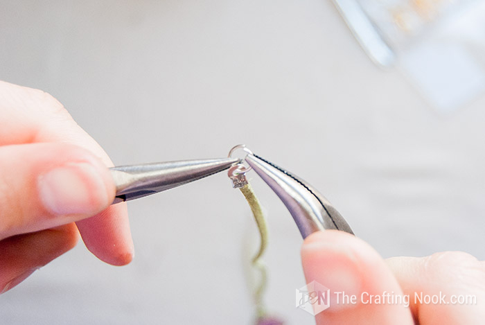 closing the jump ring with a pair of pliers
