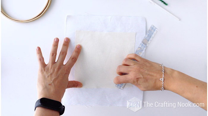 scratch the stencil with a ruler on the fabric