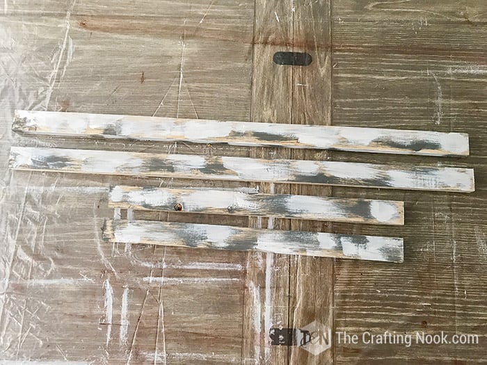 wooden slats with gray and white paint strokes