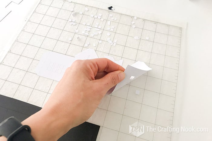 removing the piece of paper from the matt