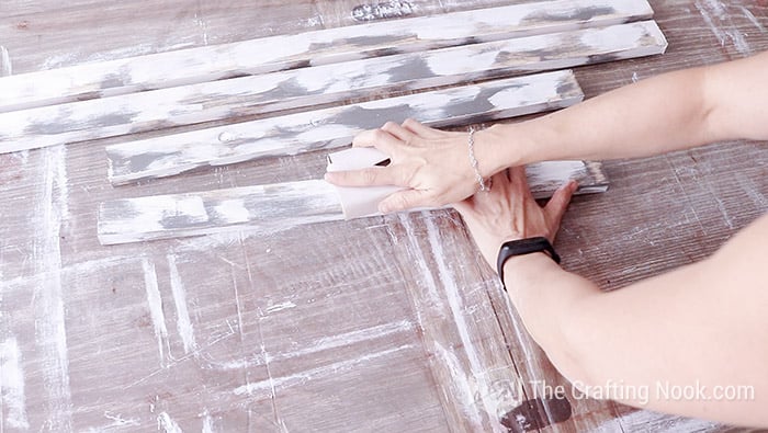 sanding the painted wood slats