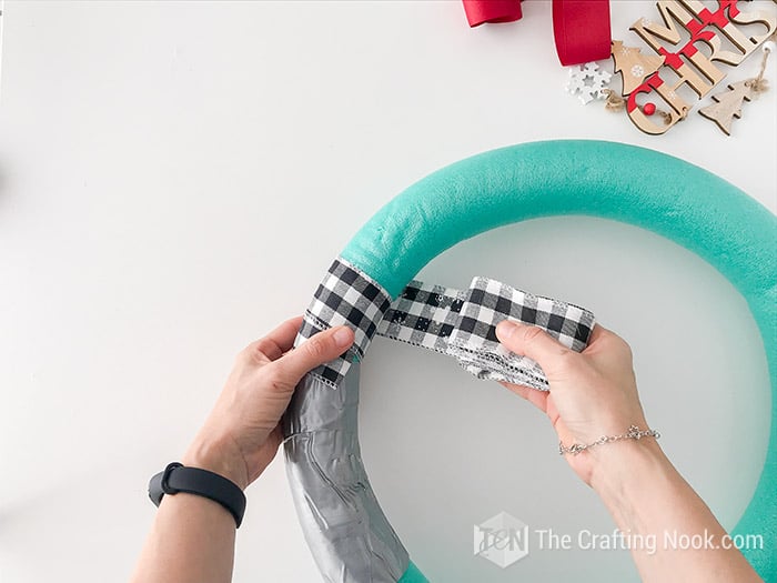 wrapping foam wreath with buffalo check ribbon