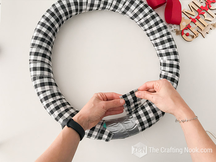 ending wrapping foam wreath with buffalo check ribbon