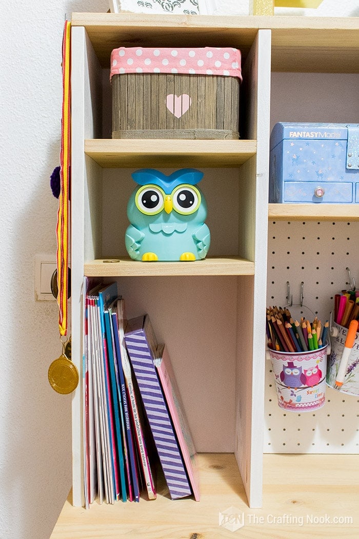 DIY Floating Desk for Kids organized with baskets, toys and books