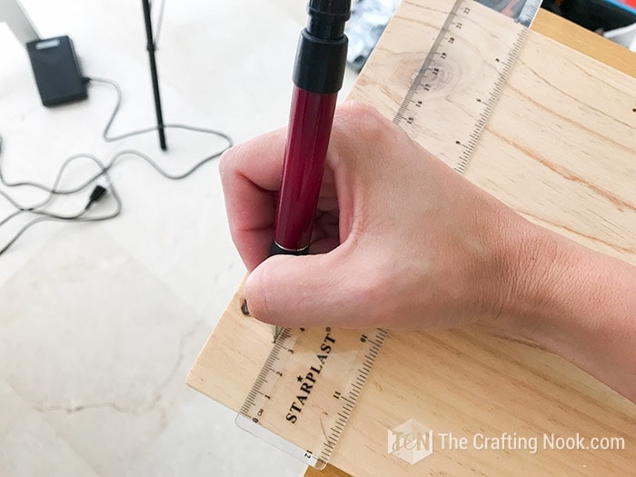 marking the measurements on the piece of wood
