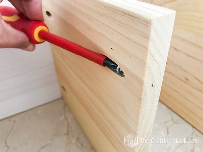 placing the screws on the free sides of the shelves
