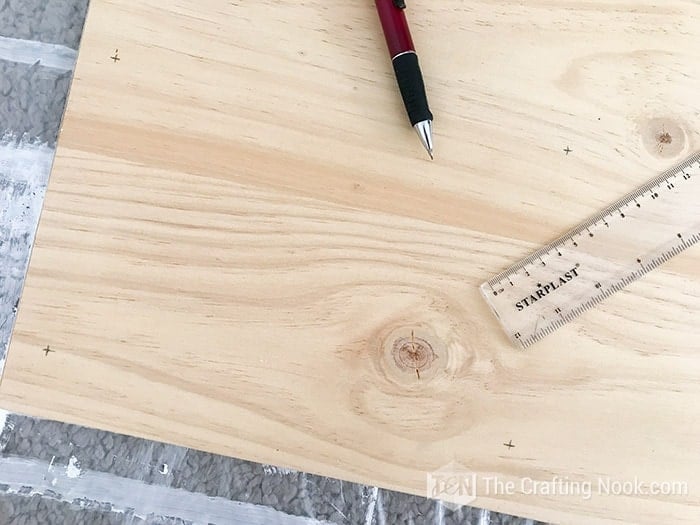 pencil marks on the wood table where they will be screwed to the structure