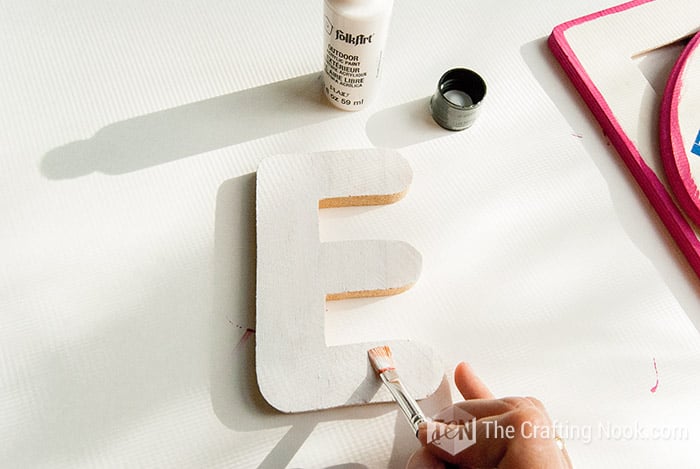 painting the painted the E letter in white with a brush