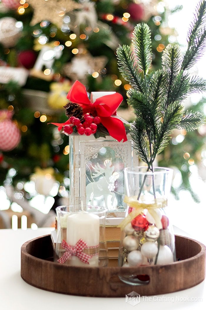 closeup of center piece on coffee table with old books, candles, a vase filled