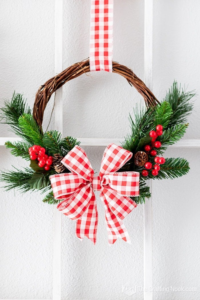 A closeup of the White and red DIY Rustic Christmas Wreath