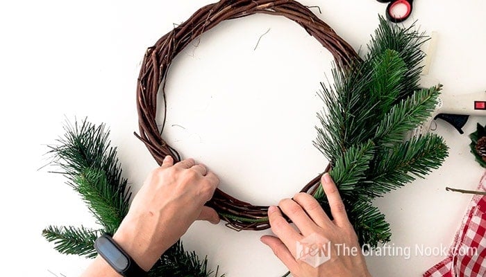 placing tree springs to fit the curve on the wreath