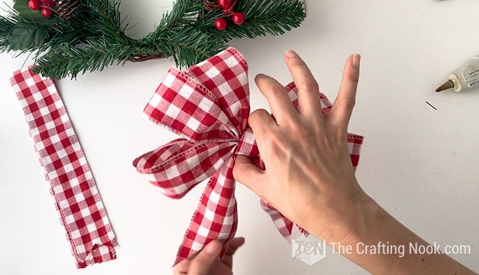 Christmas bow made with red and white buffalo check ribbon