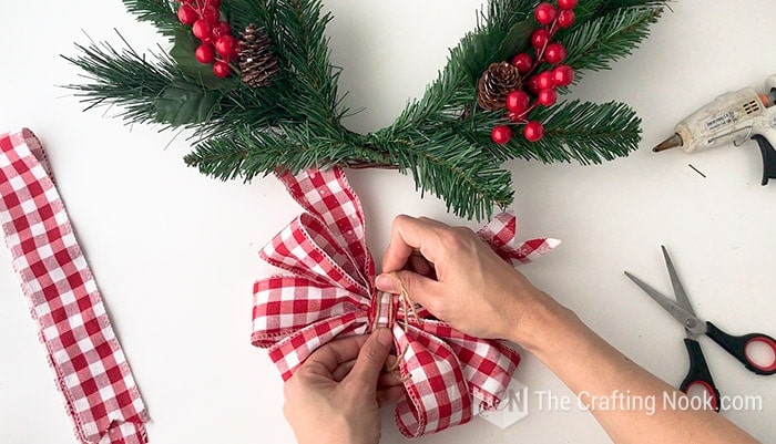 showing a hot glue to secure the bow knot on the back