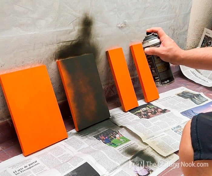 Spray painting the drawer fronts with black chalk paint