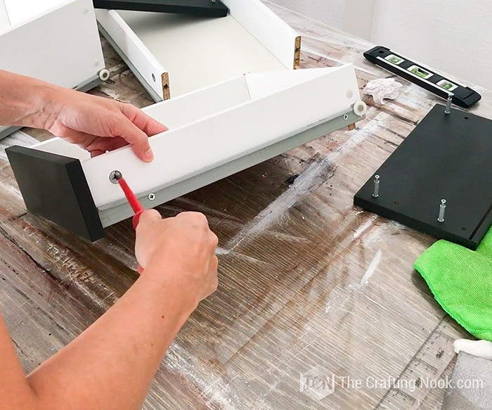 securing the drawer fronts with a screwdriver