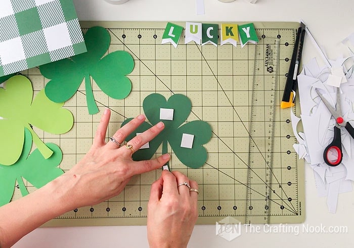 placing double-sided foam tape on shamrocks